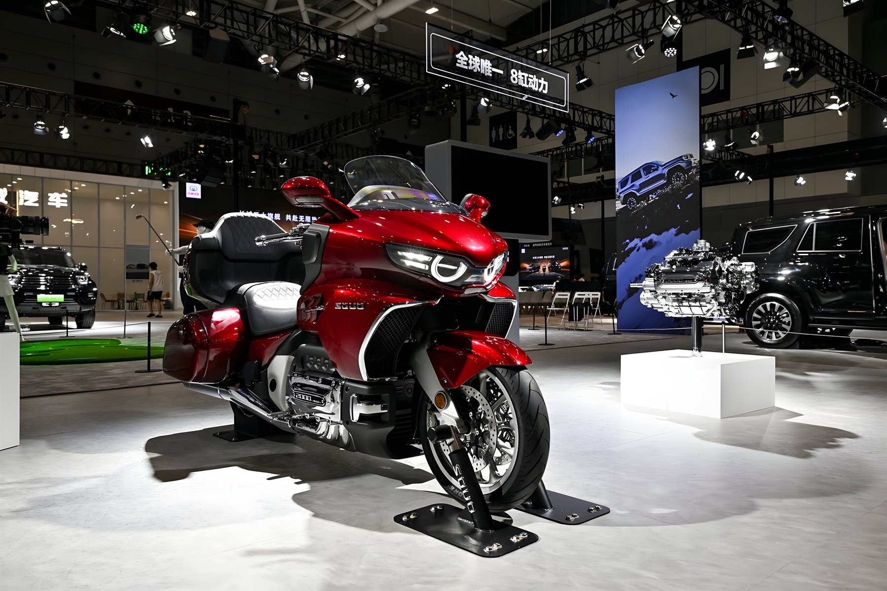 GWM Souo S2000 - Red luxury tourer at Chinese auto show booth with LED headlight and luggage system