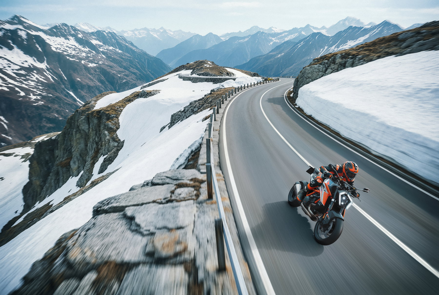 KTM 1390 Super Duke RR 2026 - aerial action shot on an Alpine pass road with serpentines