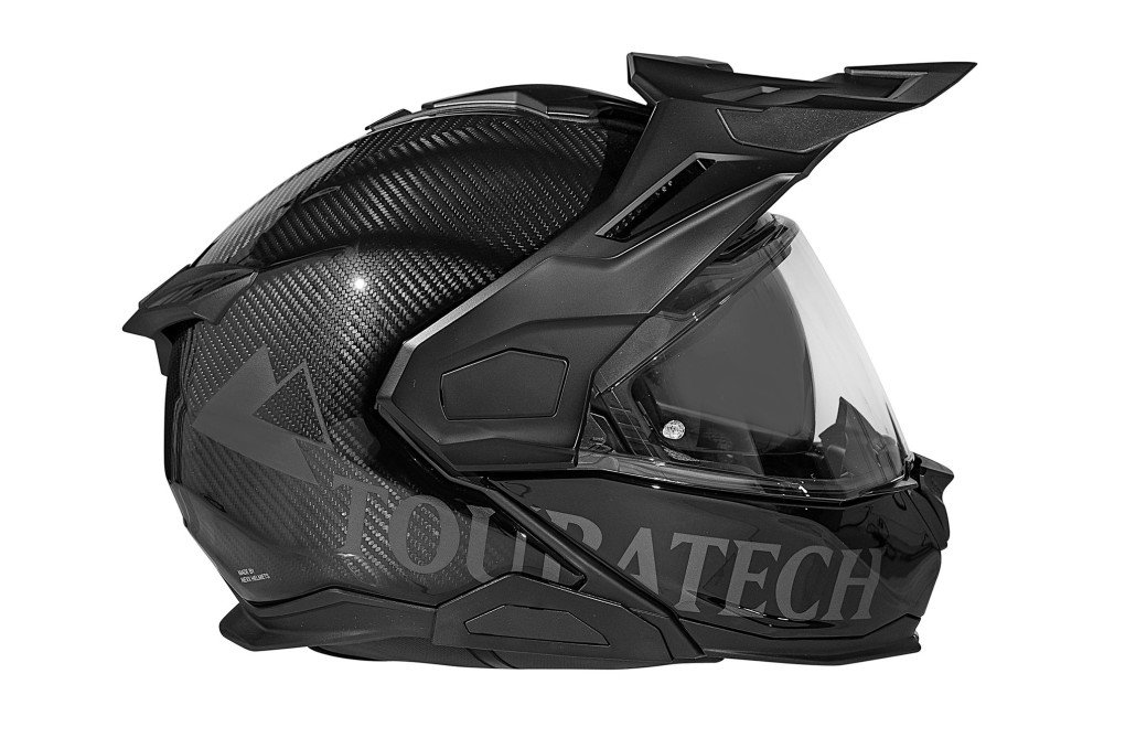 Touratech Aventuro Travel Carbon Graphite 2026 – Seitenansicht als Klapphelm mit sichtbarem Carbon-Geflecht im Graphite-Dekor