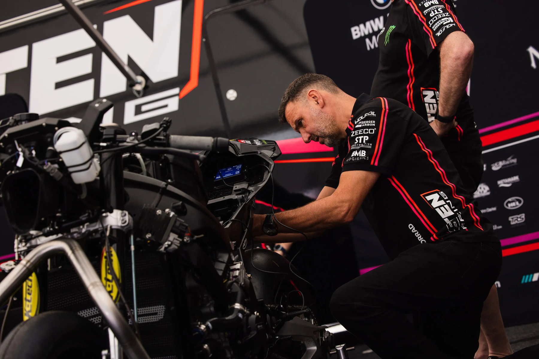 Motoröl-Mythen im Faktencheck: Warum dunkles Öl kein Mangel ist 1 Mechaniker arbeitet an BMW Superbike im TEN Kate Racing Teamzelt – Isle of Man TT 2026 Paddock