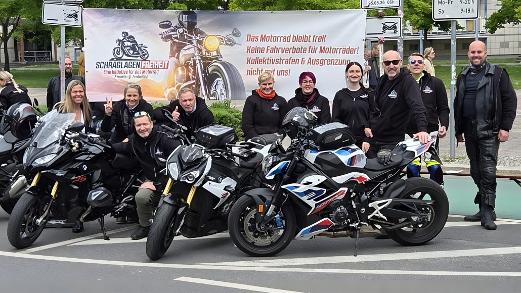 Steel & Speed 2026 – Team Schräglagenfreiheit with banner reading The Motorcycle Remains Free and three BMW motorcycles including an S 1000 RR in motorsport livery
