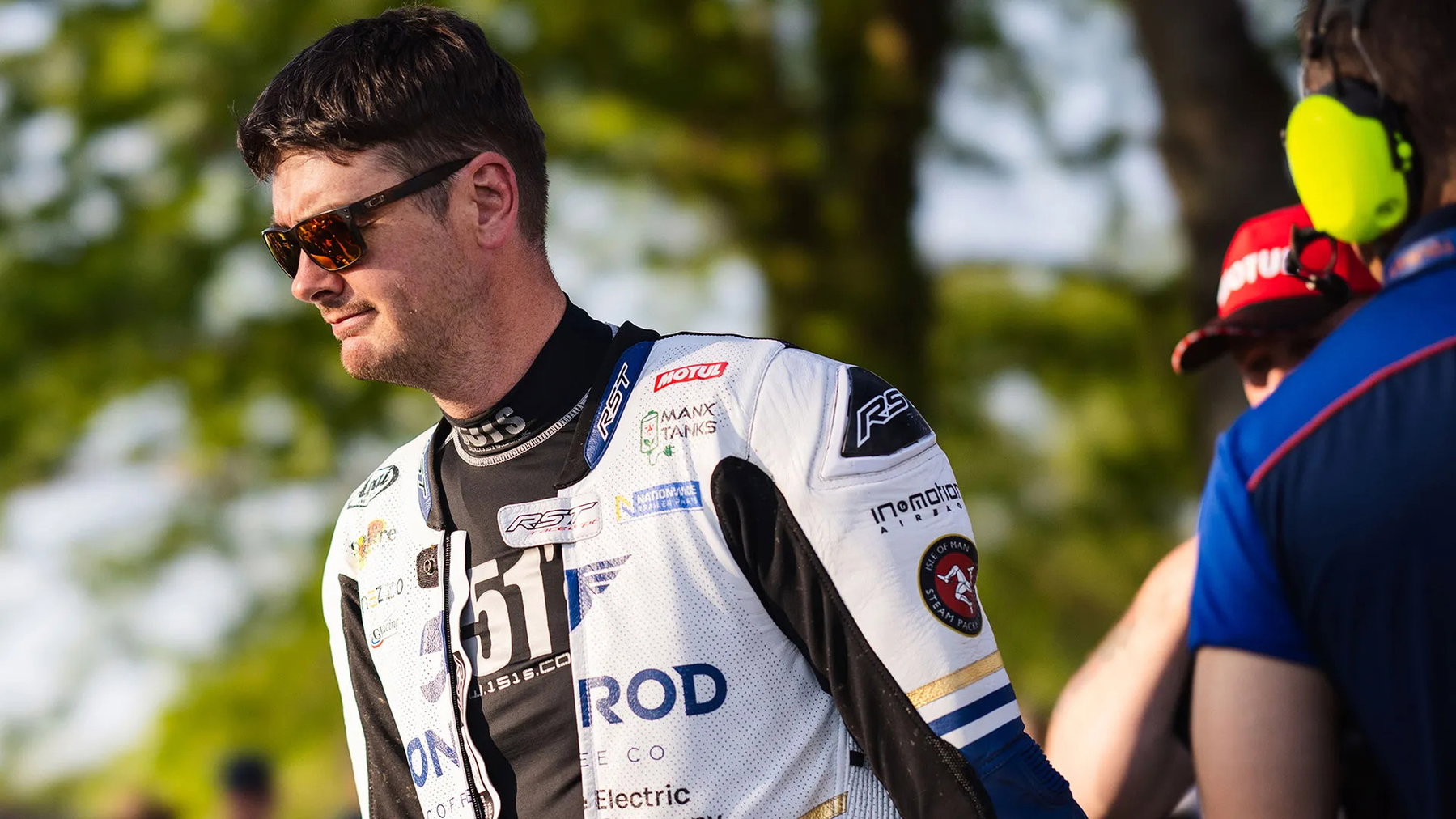 Conor Cummins wearing sunglasses and white leathers in the paddock before the start - Monster Energy Supersport TT Race 2, Isle of Man TT 2026