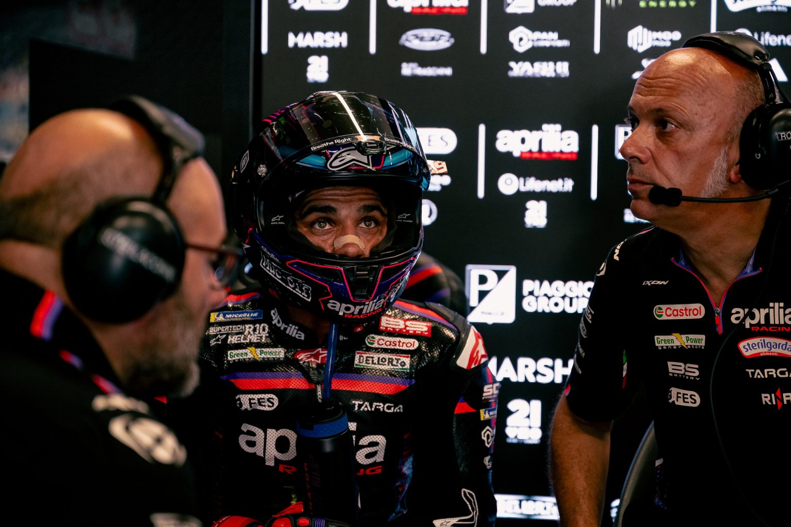 Jorge Martin im Aprilia-Lederkombi mit Helm bespricht sich in der Box mit seinen Ingenieuren – MotoGP Dutch GP Assen 2026