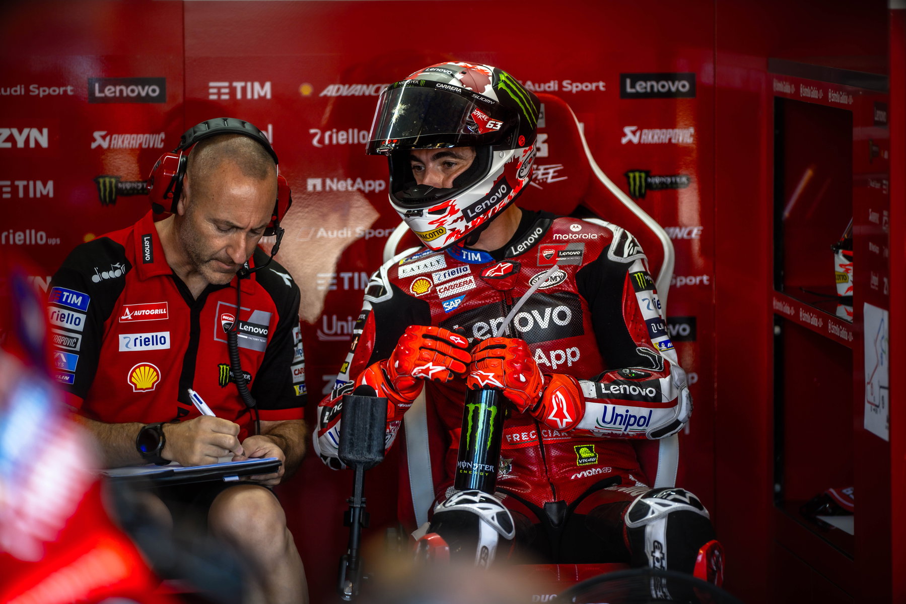 Bagnaia wins Brno Sprint: Bezzecchi crash costs championship points 5 Pecco Bagnaia with helmet in the pit box next to his race engineer – MotoGP Czech GP Brno 2026