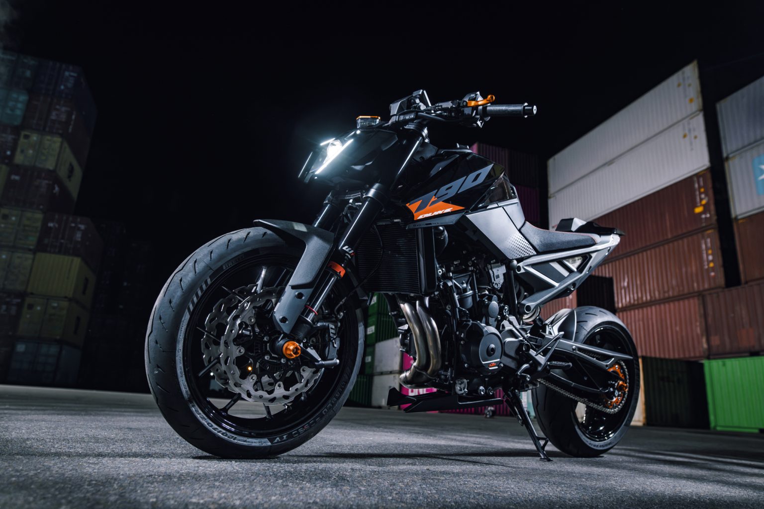 KTM 790 Duke 2027 – statische Frontansicht von links vorne im nächtlichen Containerterminal