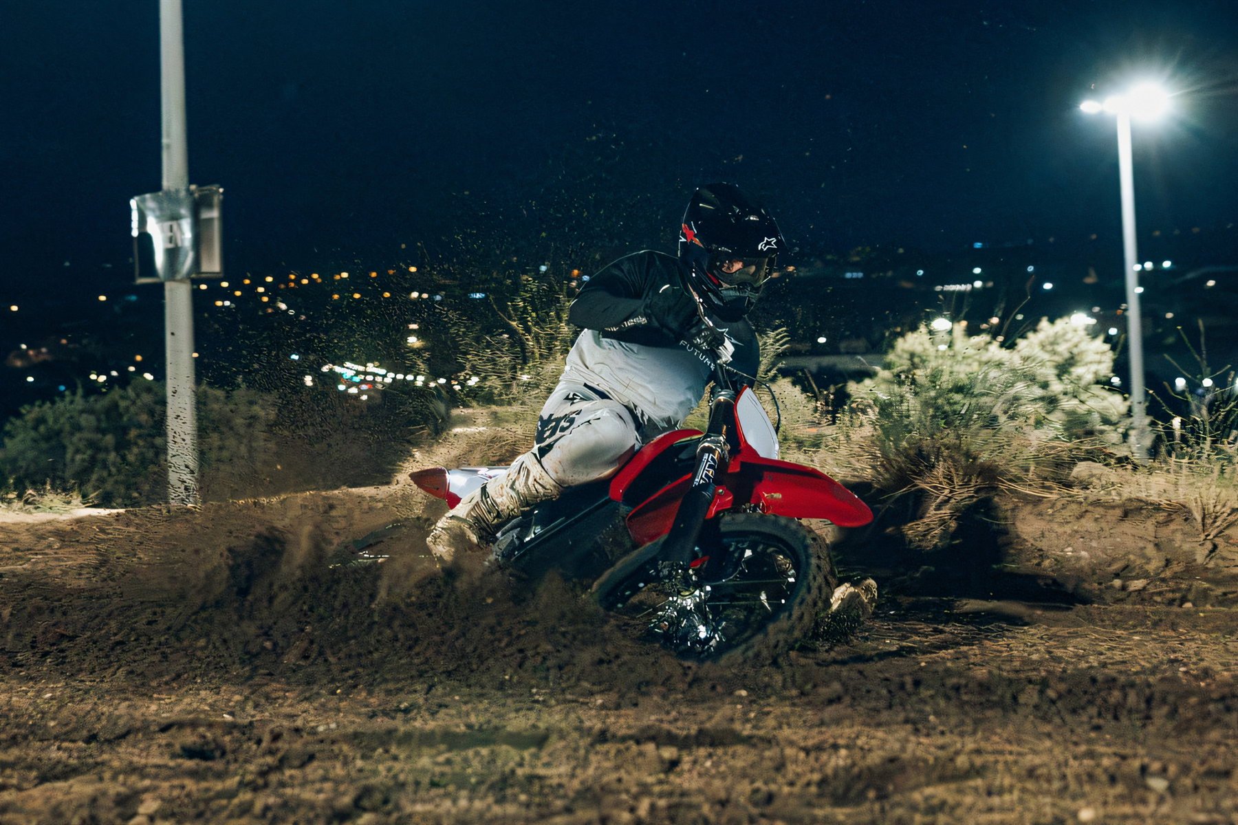 Stark Varg MX Factory Edition 2026 – Actionaufnahme in Stark Red bei Nacht auf sandigem Untergrund