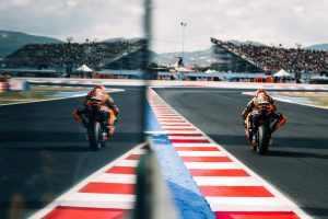 Zwei Red-Bull-KTM-Fahrer auf der Strecke von Misano, aufgenommen durch die Scheibe der Boxenmauer – MotoGP San-Marino-GP 2026
