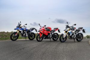BMW F 450 RR 2027 – F 450 GS, F 450 RR Sport in Racing Red und F 450 R nebeneinander auf einer Bergstraße