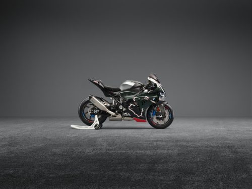BMW M 1000 RR Limited Edition Isle of Man TT 2026 – Rechte Seitenansicht in British Racing Green Uni Matt mit TT-Kurven-Grafiken, Aluminium-Tank in Satin Chrom und weißem M Montageständer, grauer Studiohintergrund
