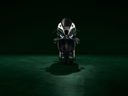 BMW M 1000 RR Limited Edition Isle of Man TT 2026 – Frontansicht mit LED-Scheinwerfer, M Logo auf Windschild, Carbon-Winglets und British Racing Green Uni Matt Lackierung, dunkles Studio mit grünem Spotlight