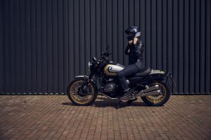 BMW R 12 nineT 2025 – Seitenansicht mit Fahrerin, Avus-Silber