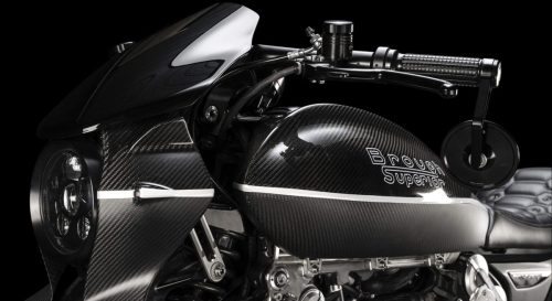 Brough Superior Dagger S 2026 – Detailansicht Frontpartie und Tank im Studio, Carbon-Verkleidung mit LED-Scheinwerfer, getönte Scheibe, Brough Superior Logo, gesteppter Ledersattel teilweise sichtbar