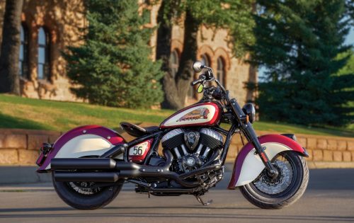 Dreiviertelansicht von vorn rechts in Indian Motorcycle Red und Cream vor einem Sandsteingebäude in Sturgis, South Dakota