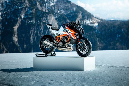 KTM 1390 Super Duke RR 2026 – Front-Dreiviertelansicht rechts auf Podest im Schnee vor verschneiten Bergen