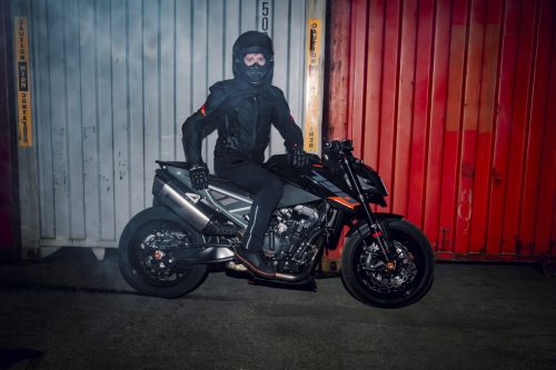 KTM 790 Duke 2027 – Fahrer sitzt auf dem Motorrad vor rotem Container