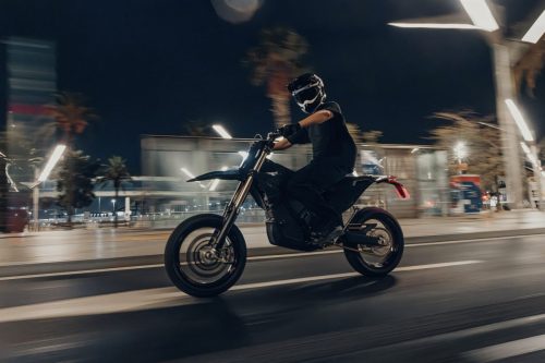 Stark VARG SM Sköll 2026 – Fahrer in Kurvenfahrt durch beleuchtete Stadtstraße bei Nacht, Bewegungsunschärfe