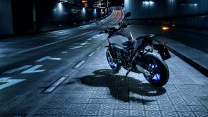 Yamaha MT-09 SP 2027 – in Icon Performance im Stand auf einer nächtlichen Straße, Heckansicht